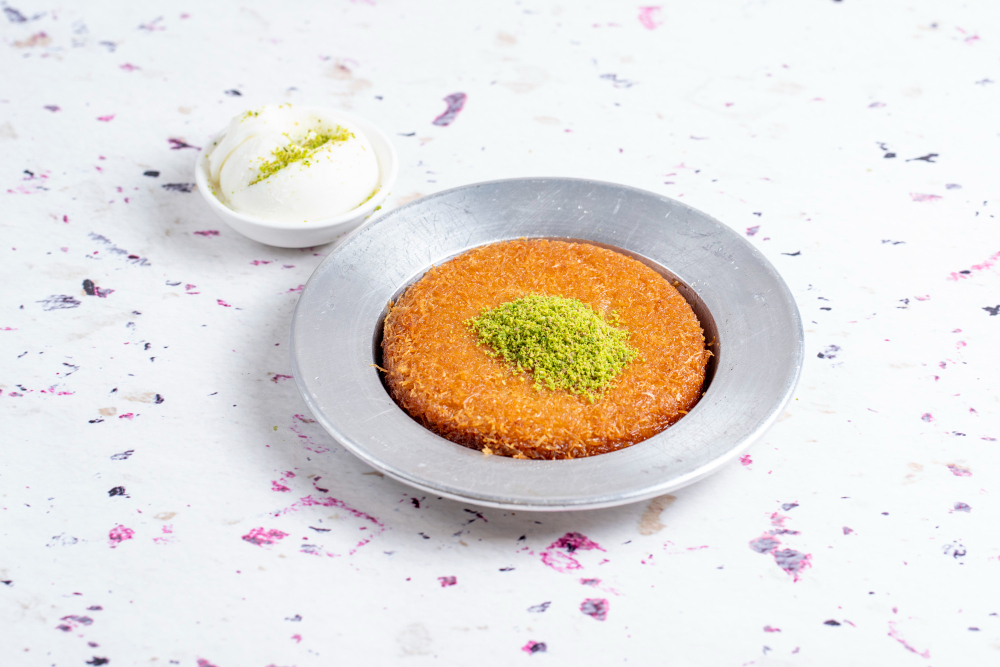 Scrumptious Künefe, a warm cheese-filled pastry topped with pistachios
